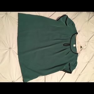 Green blouse trimmed in black